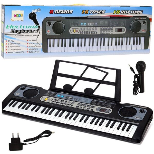 Keyboard z mikrofonem, stojakiem i nutami